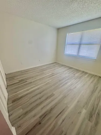 a view of an empty room and wooden floor