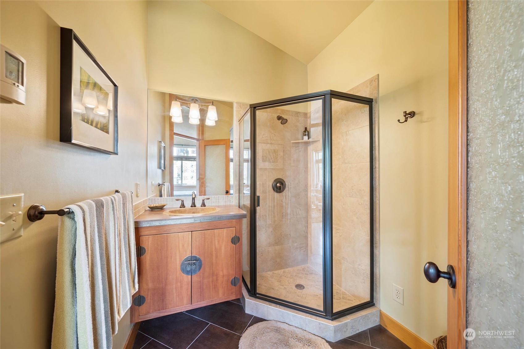 341 South State Street Bellingham, WA 98225 - Photo 25 of 40 a en suite bathroom with a shower sink and mirror