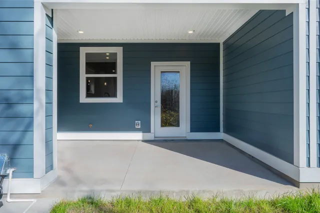 a view of a patio with a table and chairs and potted plants