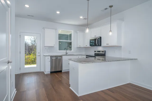a kitchen with a sink a window and stainless steel appliances