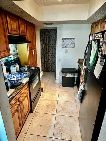 a kitchen with stainless steel appliances granite countertop a stove and a refrigerator