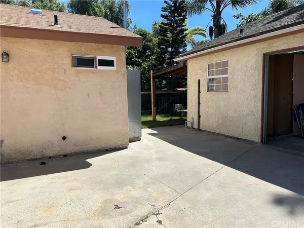 a view of a backyard with a small cabin and wooden fence