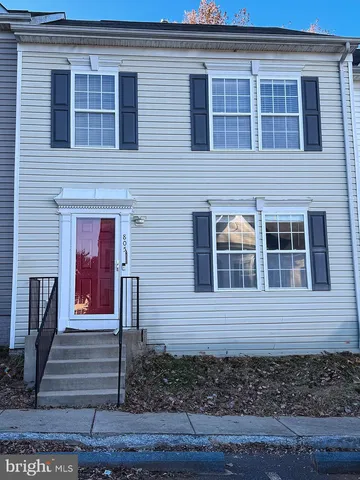 a view of a house with wooden door and a window