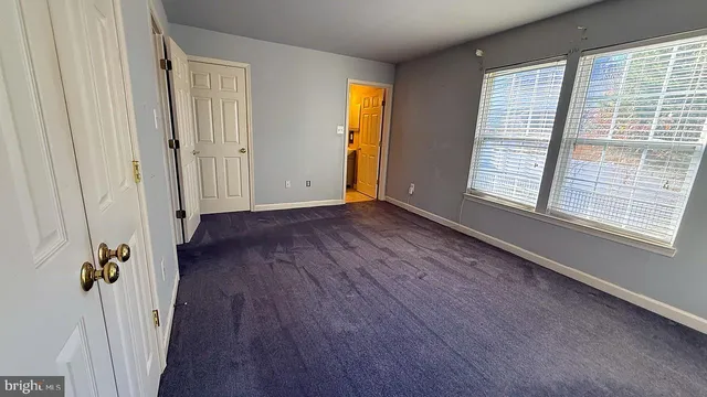 a view of a room with wooden floor and windows