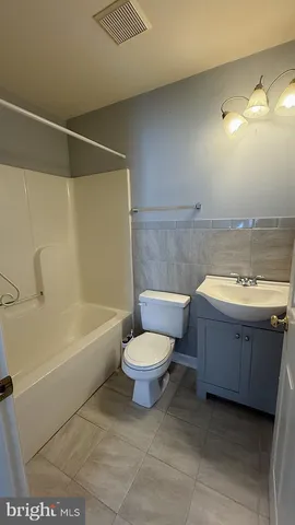 a bathroom with a sink a toilet and bathtub