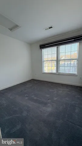 an empty room with a empty space and windows