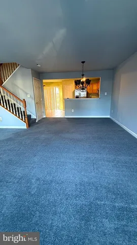 an empty room with a window and fireplace