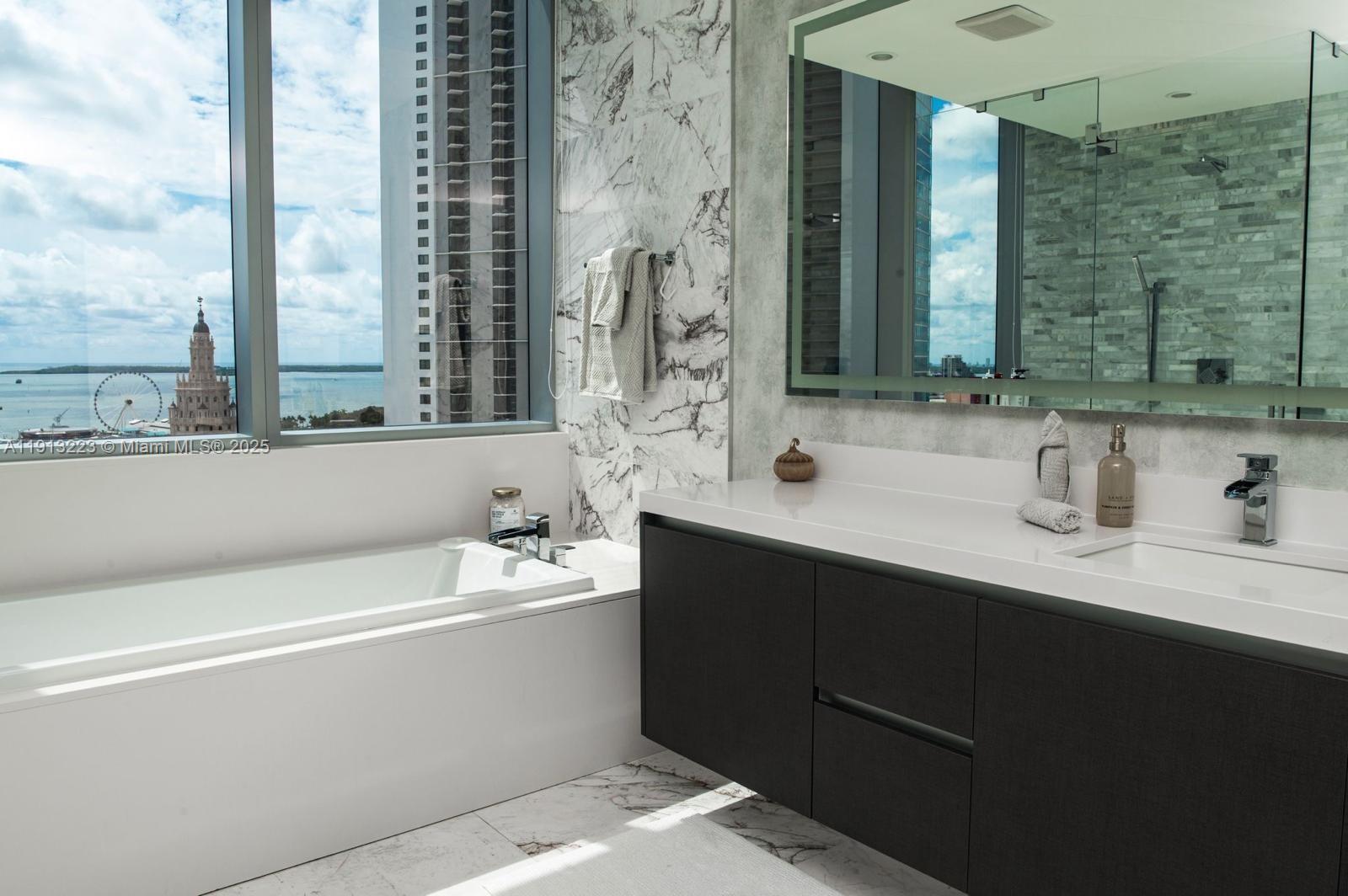 851 Northeast 1st Avenue, Unit 1811 Miami, FL 33132 - Photo 12 of 57 a bathroom with a bathtub and a sink