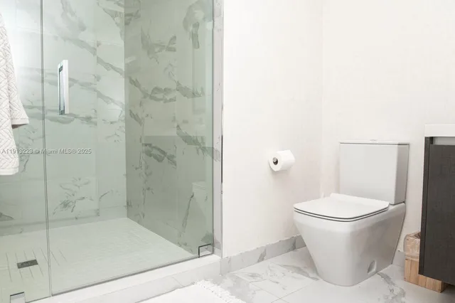 a white toilet sitting next to a bathroom sink