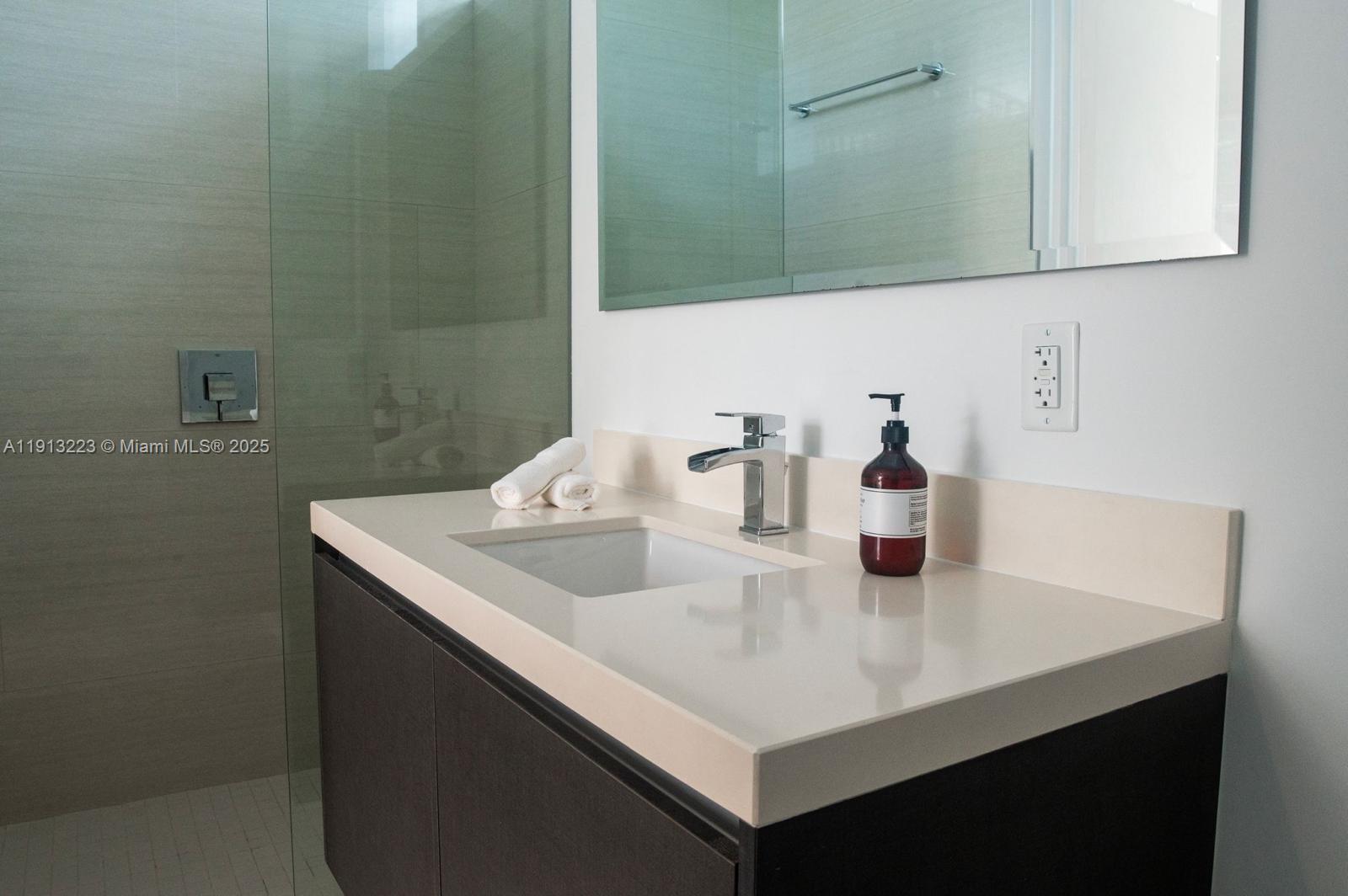 851 Northeast 1st Avenue, Unit 1811 Miami, FL 33132 - Photo 17 of 57 a close view of a sink and a mirror in a bathroom