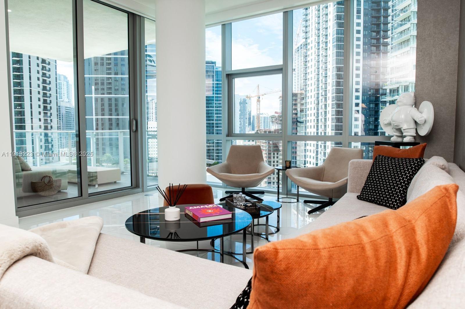 851 Northeast 1st Avenue, Unit 1811 Miami, FL 33132 - Photo 2 of 57 a living room with furniture and floor to ceiling windows