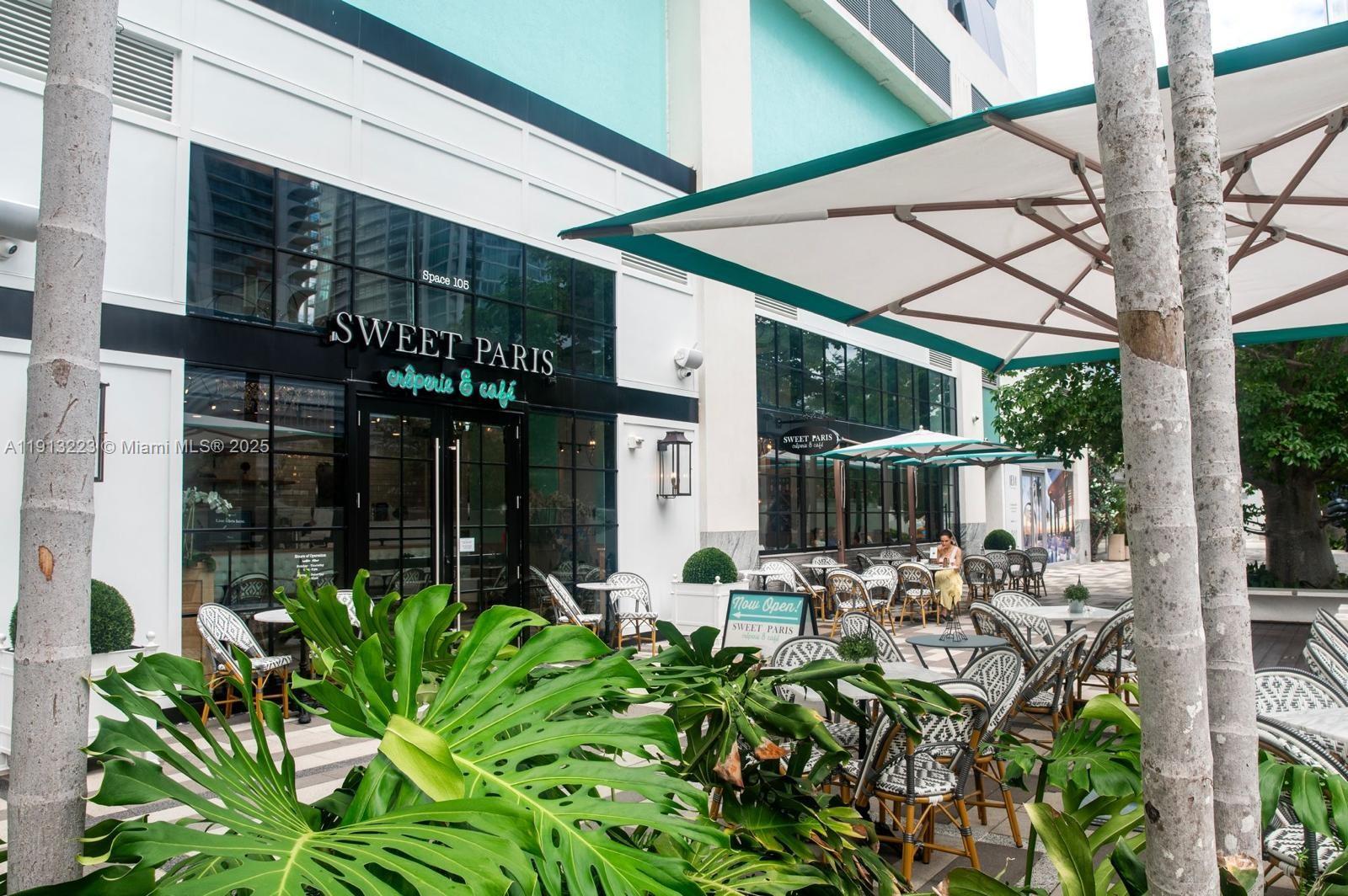 851 Northeast 1st Avenue, Unit 1811 Miami, FL 33132 - Photo 21 of 57 a view of a patio with table and chairs potted plants and floor to ceiling window and potted plants