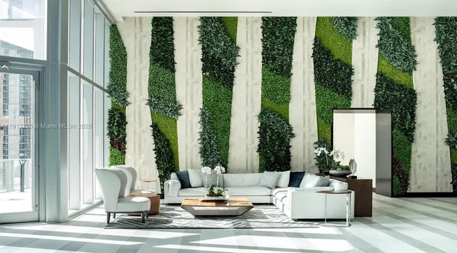 a lobby with furniture and floor to ceiling window