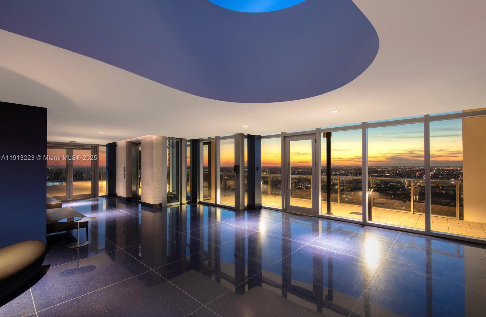 851 Northeast 1st Avenue, Unit 1811 Miami, FL 33132 - Photo 42 of 57 a lobby with furniture and floor to ceiling window