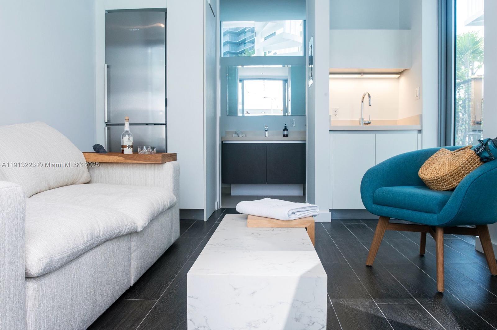 851 Northeast 1st Avenue, Unit 1811 Miami, FL 33132 - Photo 5 of 57 a bedroom with a bed and wooden floor