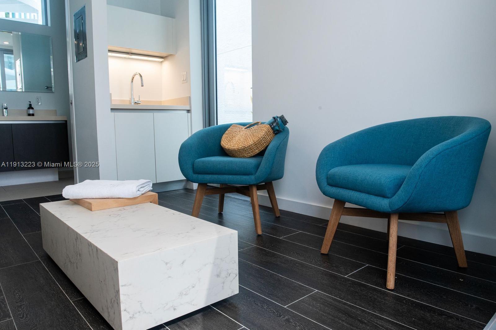 851 Northeast 1st Avenue, Unit 1811 Miami, FL 33132 - Photo 7 of 57 a living room with furniture and a chair