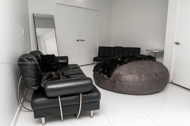 a bedroom with a bed and glass window