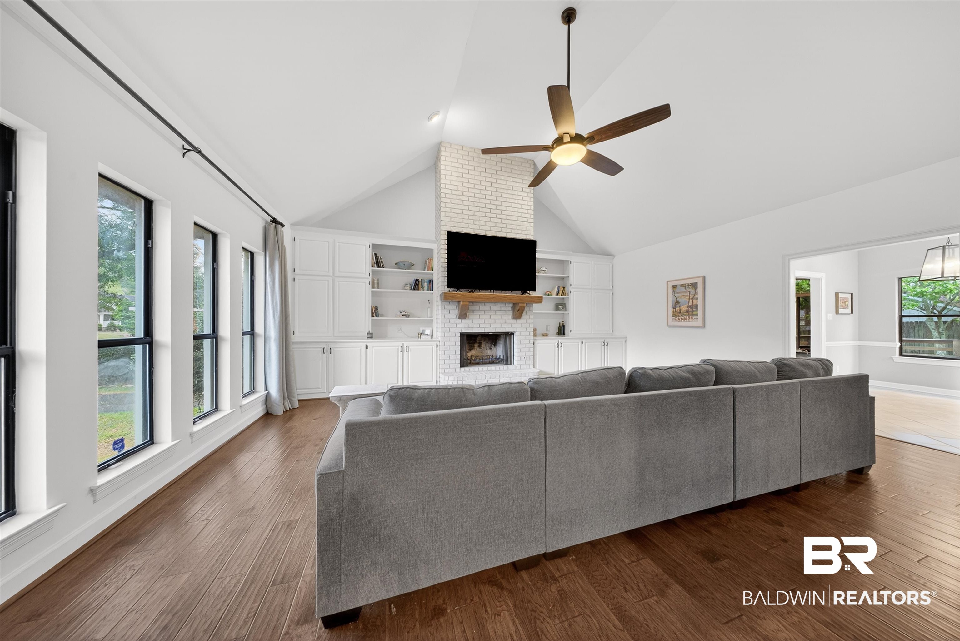 1250 Savannah Drive Mobile, AL 36609 - Photo 8 of 35 Living room with dark wood finished floors, a ceiling fan, a high ceiling, and a fireplace