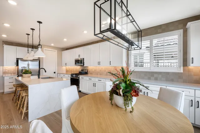 a kitchen with a table chairs and microwave