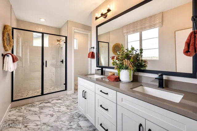 a bathroom with a shower sink and mirror