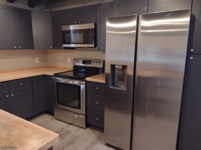 a kitchen with cabinets and stainless steel appliances
