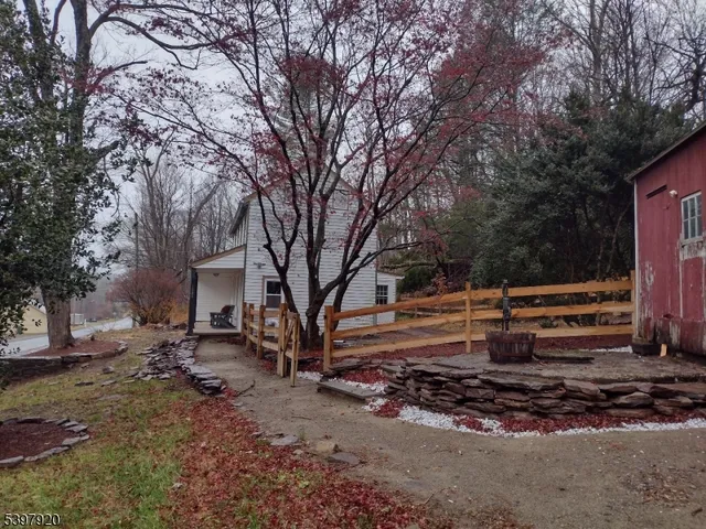 a backyard of a house with barbeque oven table and chairs
