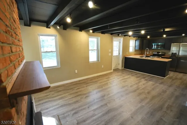 a large room with wooden floor and windows