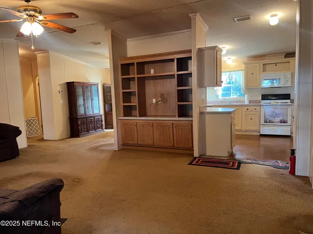 a view of a livingroom with furniture and a window