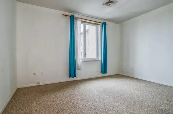 a view of an empty room and a window