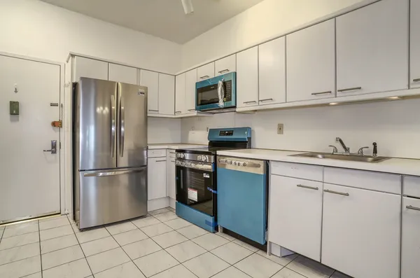 a kitchen with stainless steel appliances granite countertop a refrigerator and a sink
