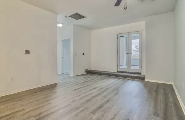 a view of a kitchen with furniture and wooden floor
