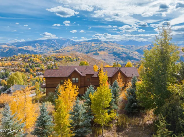 an aerial view of residential houses with yard