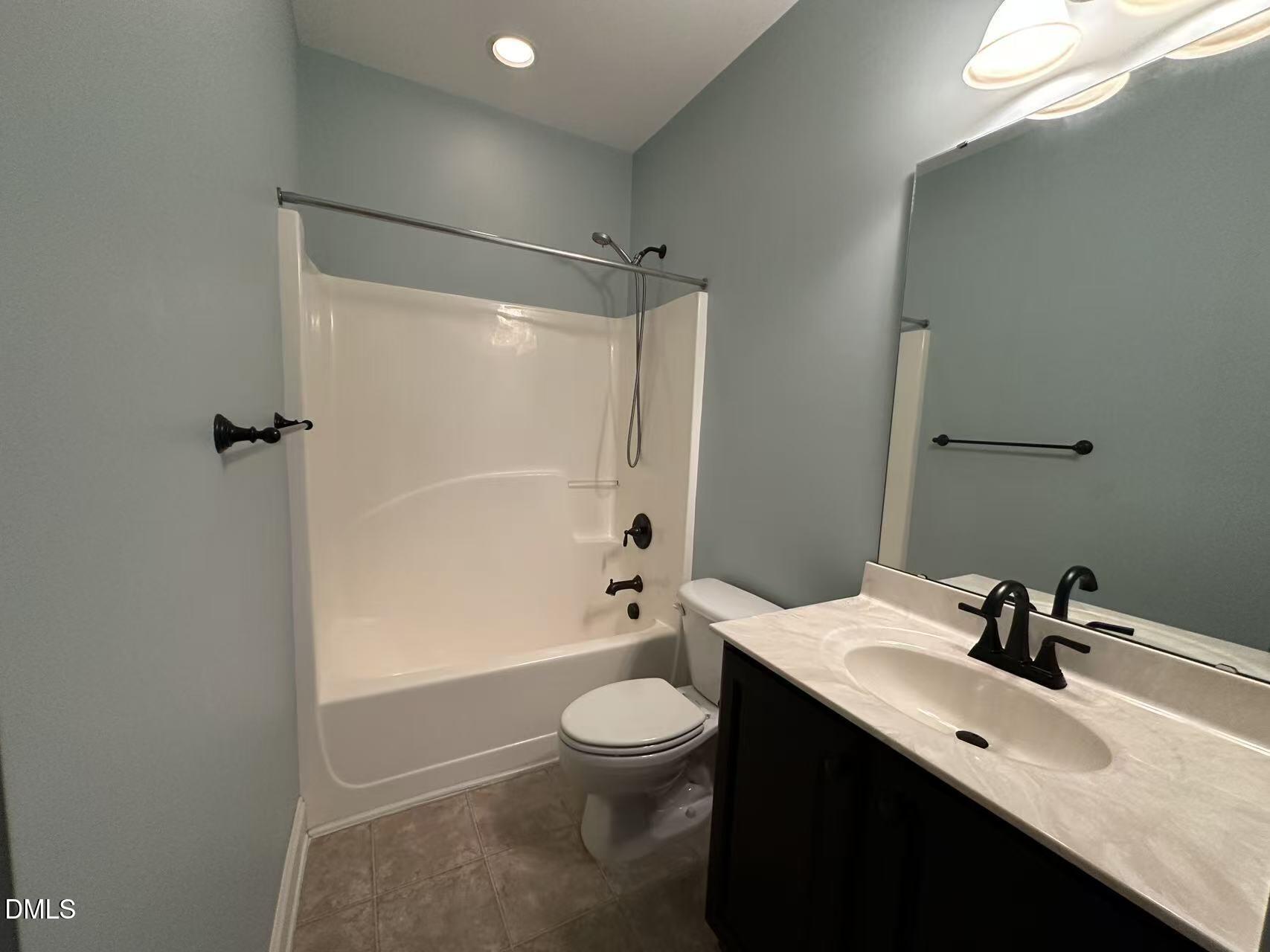 1056 Indigo Ridge Place Cary, NC 27519 - Photo 23 of 33 a bathroom with a sink a toilet and shower