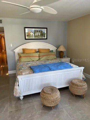 a bedroom with bed and a chandelier