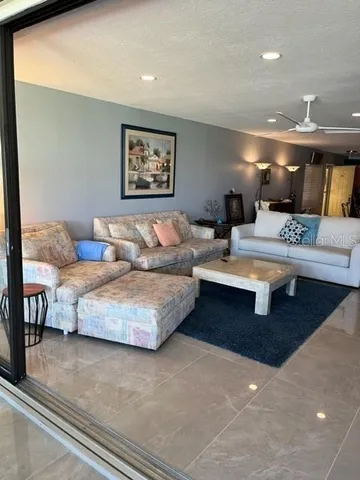 a living room with couches and painting on the wall