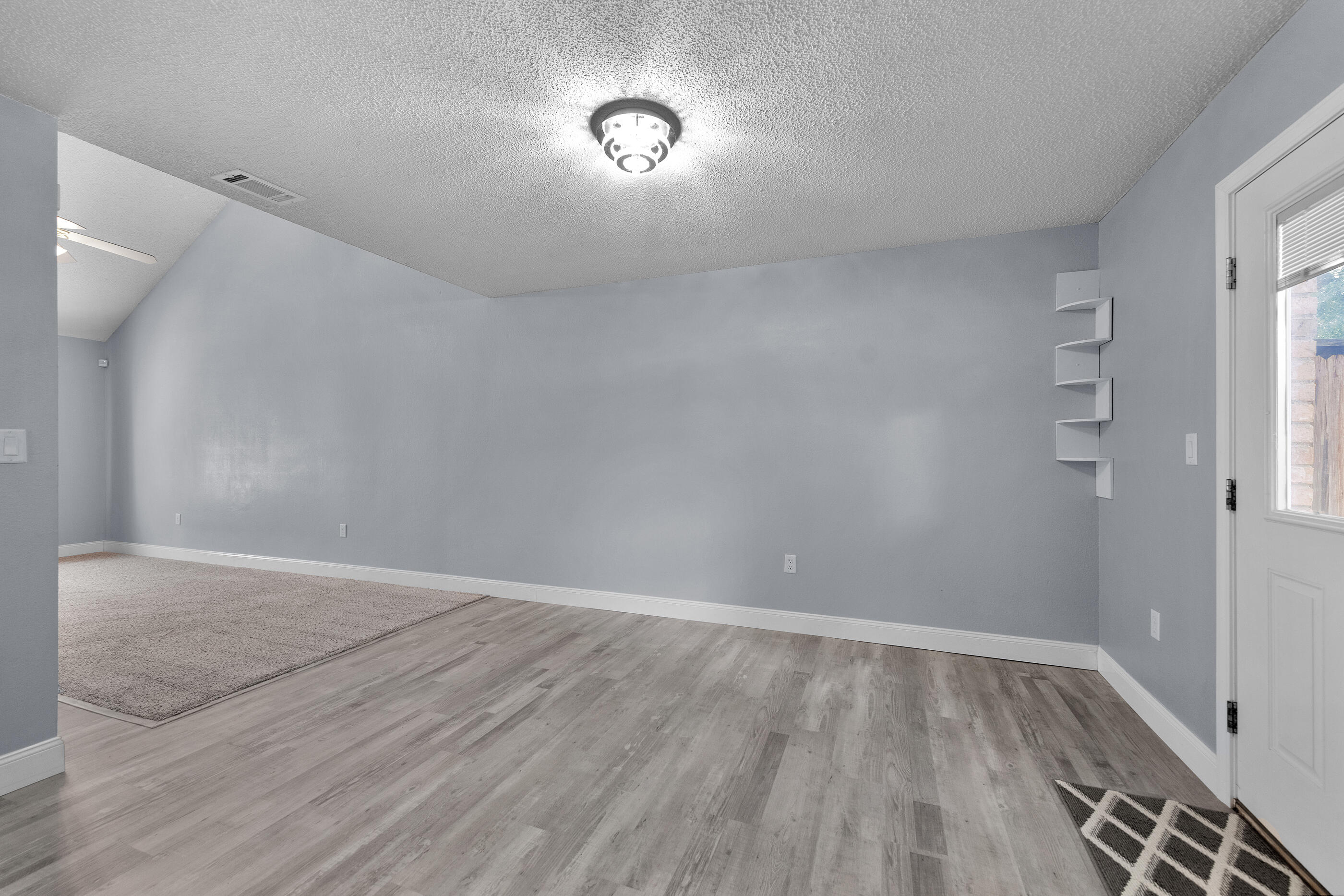 809 Valley Road Crestview, FL 32539 - Photo 12 of 24 a view of an empty room with wooden floor and a window
