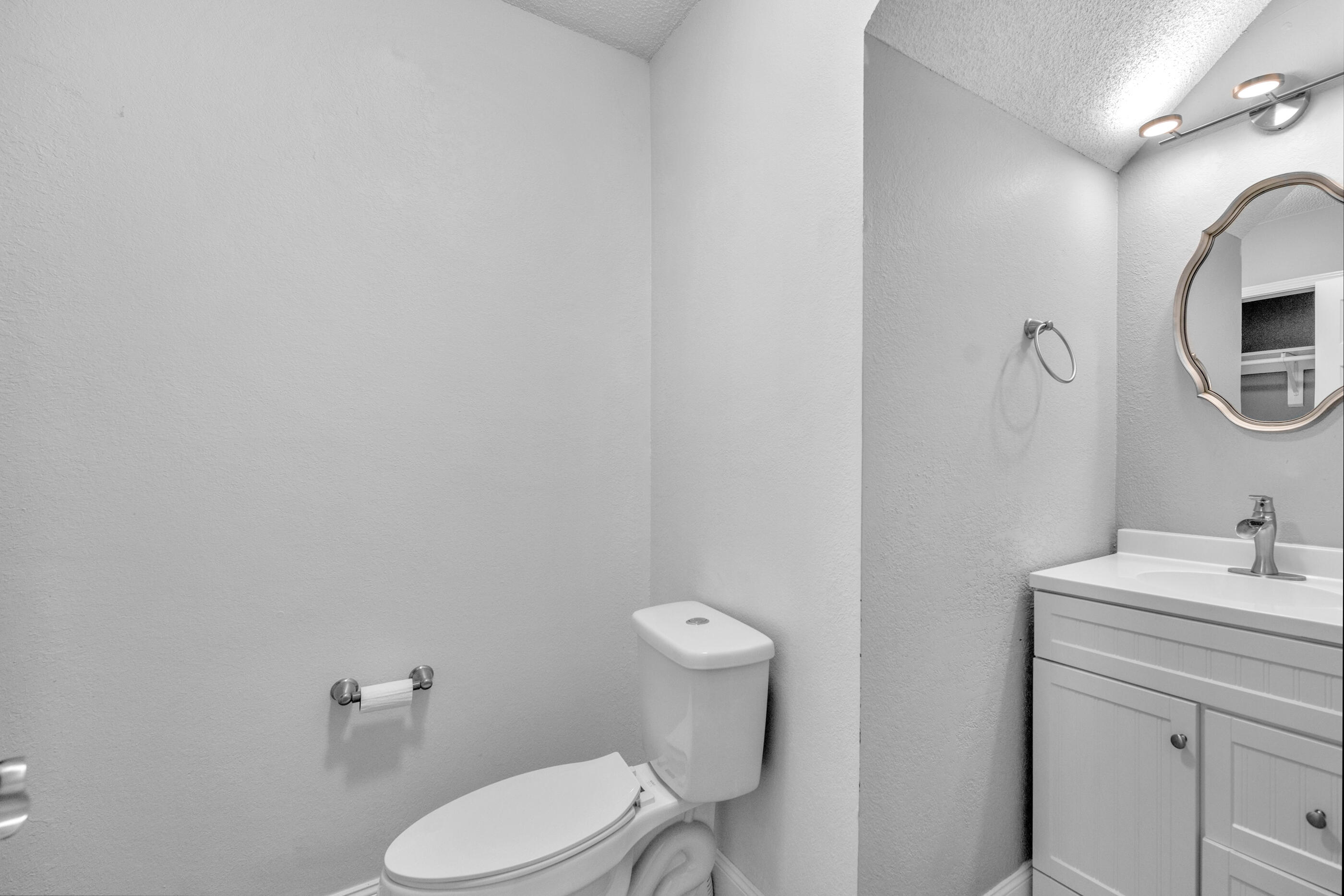 809 Valley Road Crestview, FL 32539 - Photo 18 of 24 a bathroom with a toilet sink and mirror