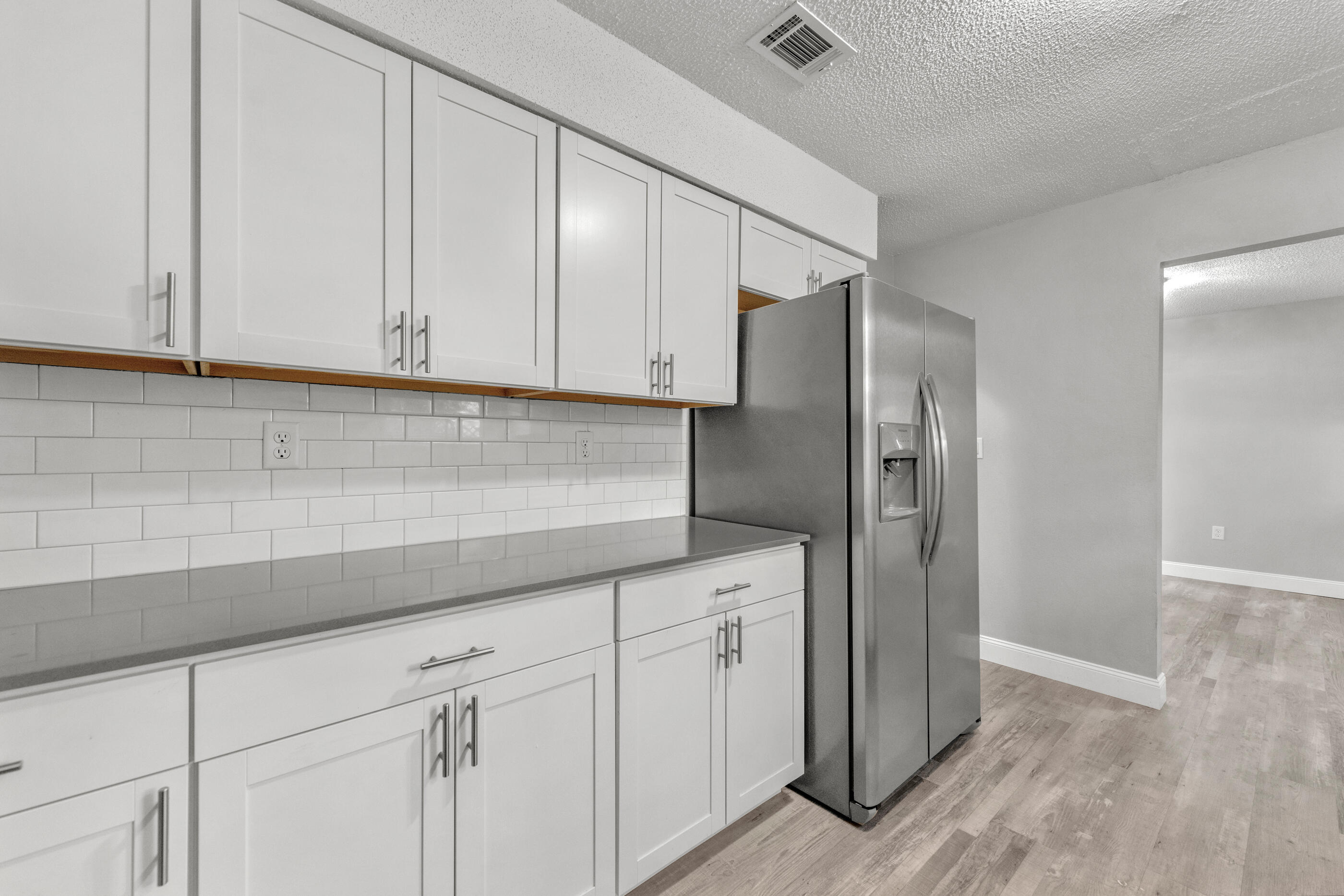 809 Valley Road Crestview, FL 32539 - Photo 2 of 24 a kitchen with cabinets and a refrigerator