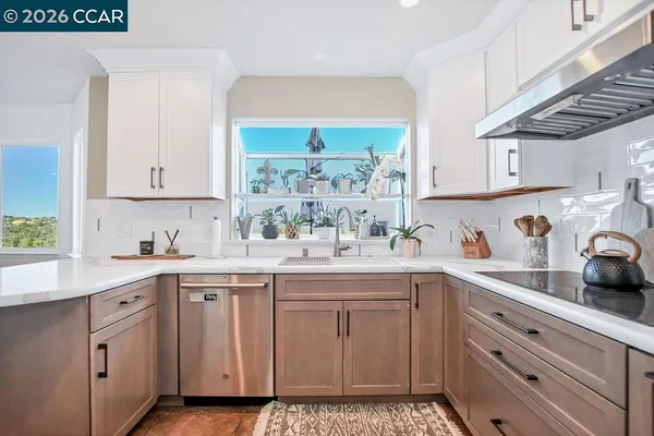 a kitchen with a sink window and cabinets