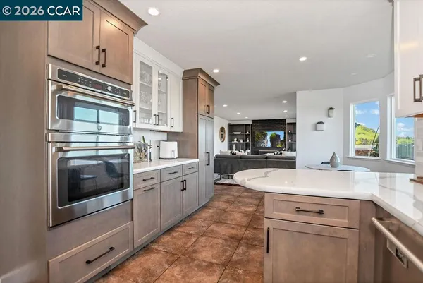 a kitchen with stainless steel appliances granite countertop a sink and a stove top oven