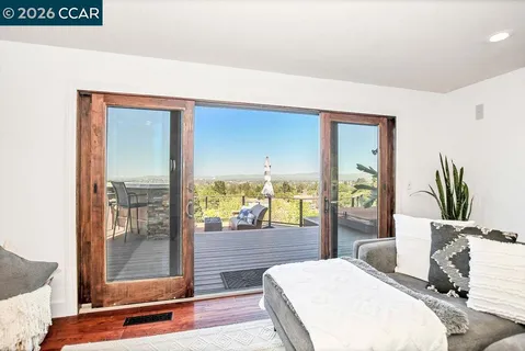 a bedroom with a bed and large window