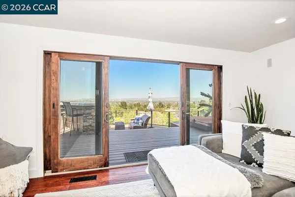 a bedroom with a bed and large window