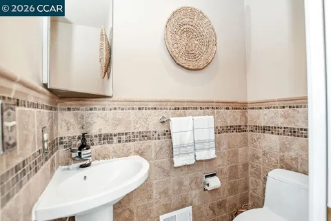 a bathroom with a sink mirror vanity and toilet