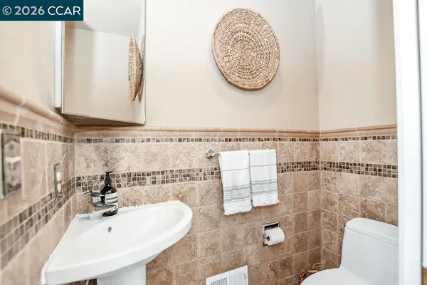 a bathroom with a sink mirror vanity and toilet