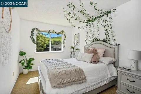 a bedroom with bed and a window