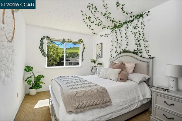 a bedroom with bed and a window