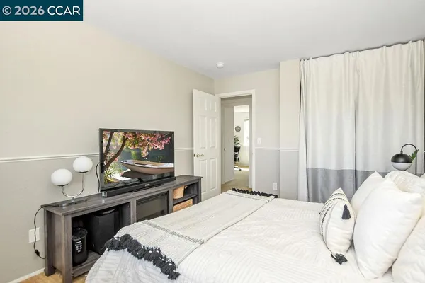 a bedroom with a bed and a flat screen tv