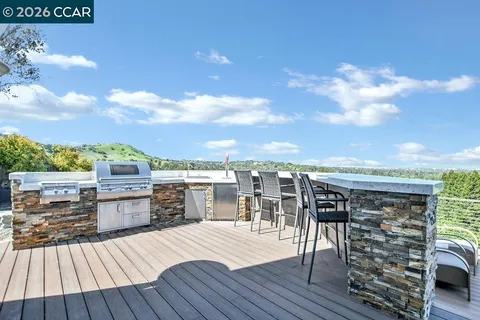 a view of roof deck outdoor seating and city view