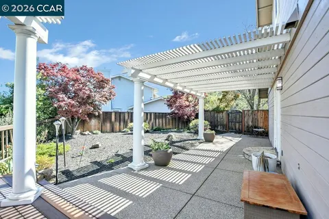a view of a patio with a table and chairs