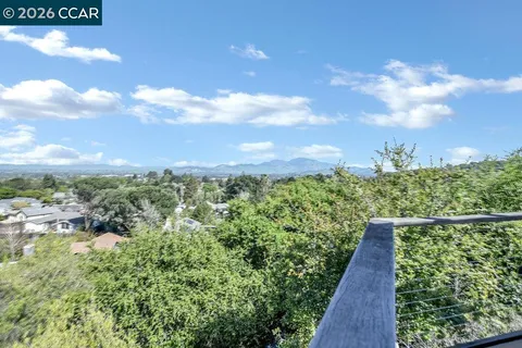 a view of a yard with wooden fence